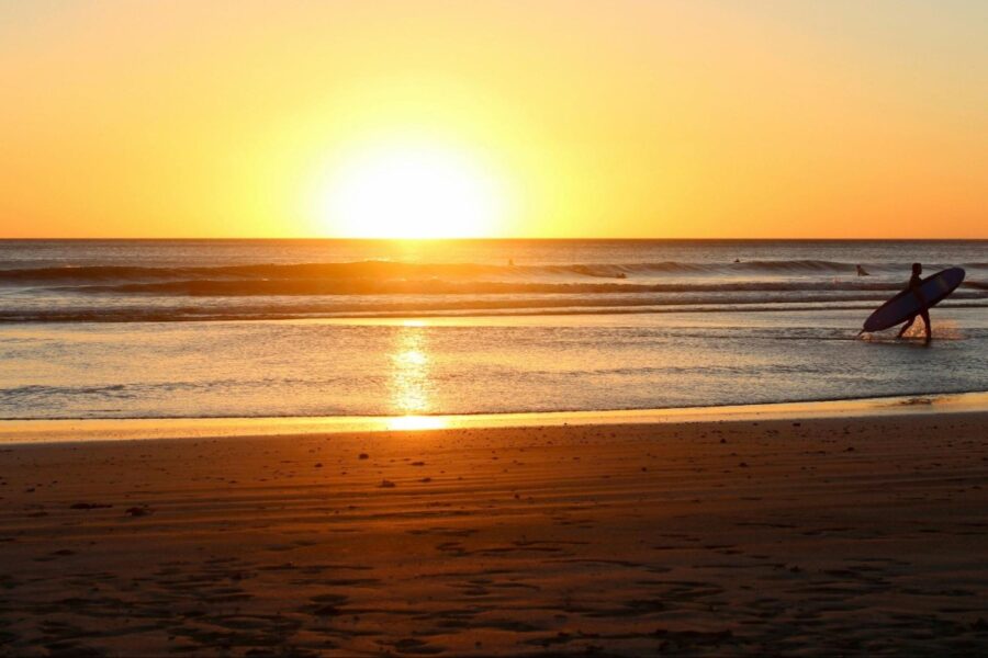 surfers at sunset on a Nicaraguan beach