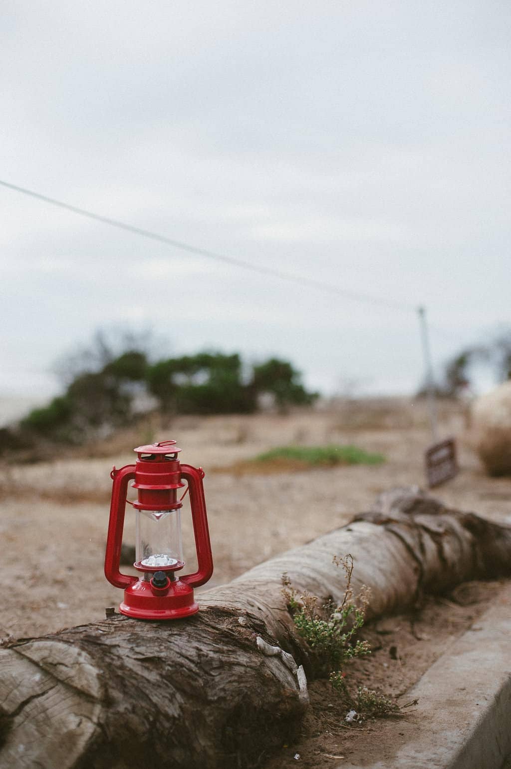 camping lantern on wood stump