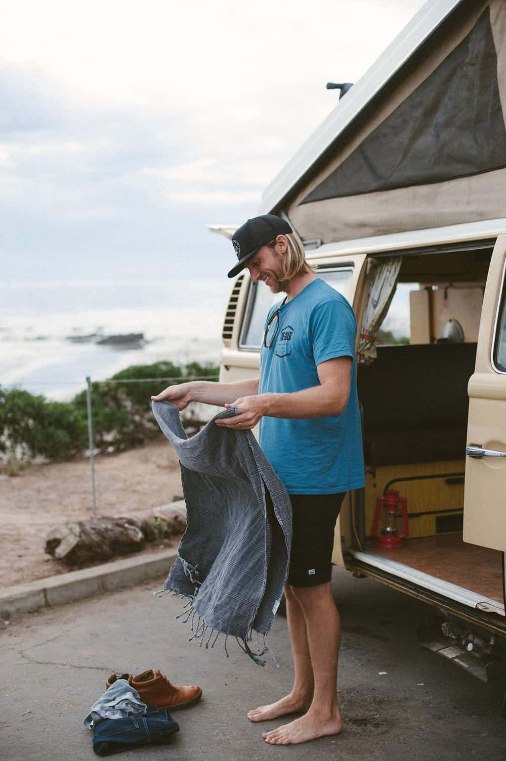 vw bus road trip surfer with turkish beach towel