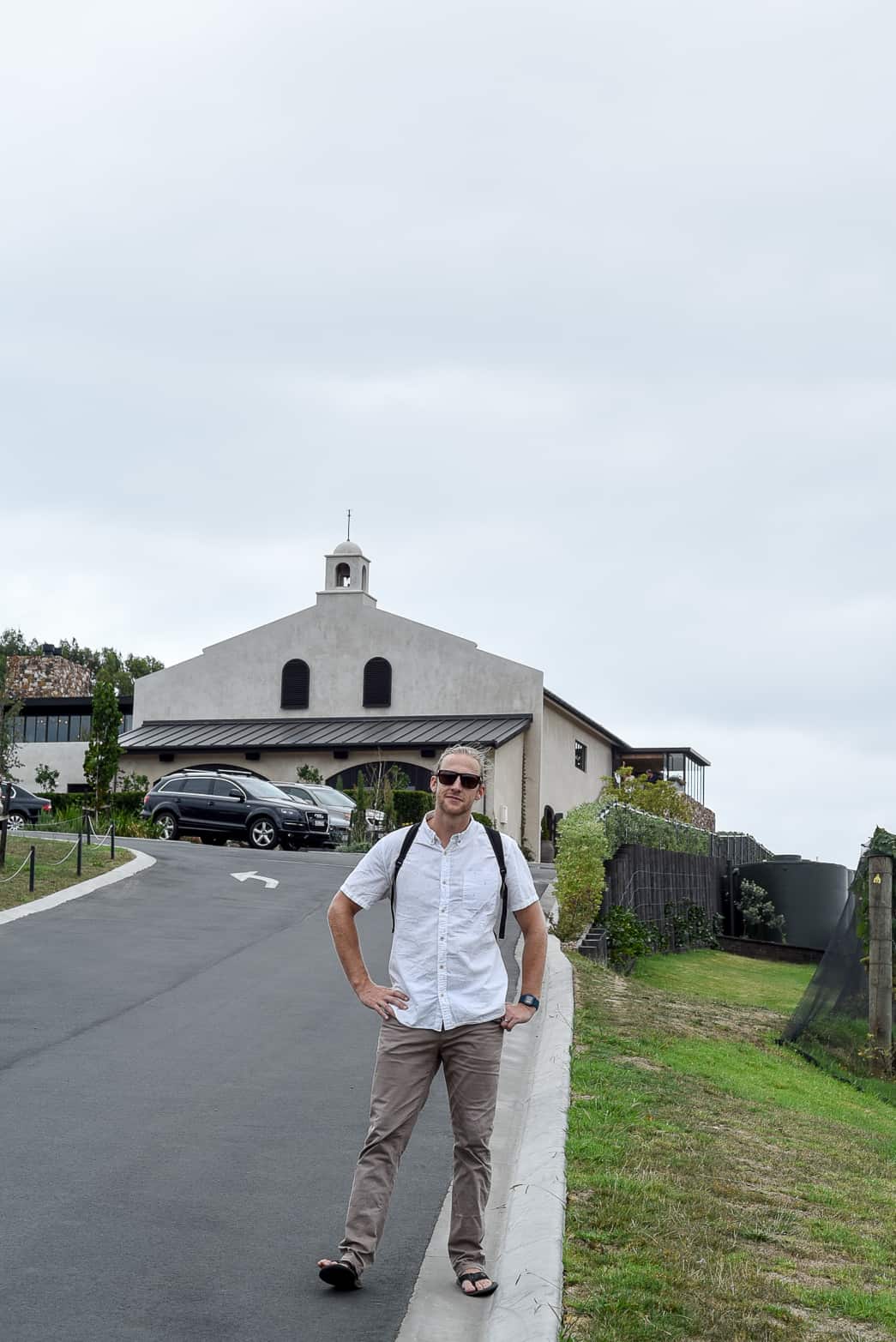 waiheke island man posing in front of vineyard