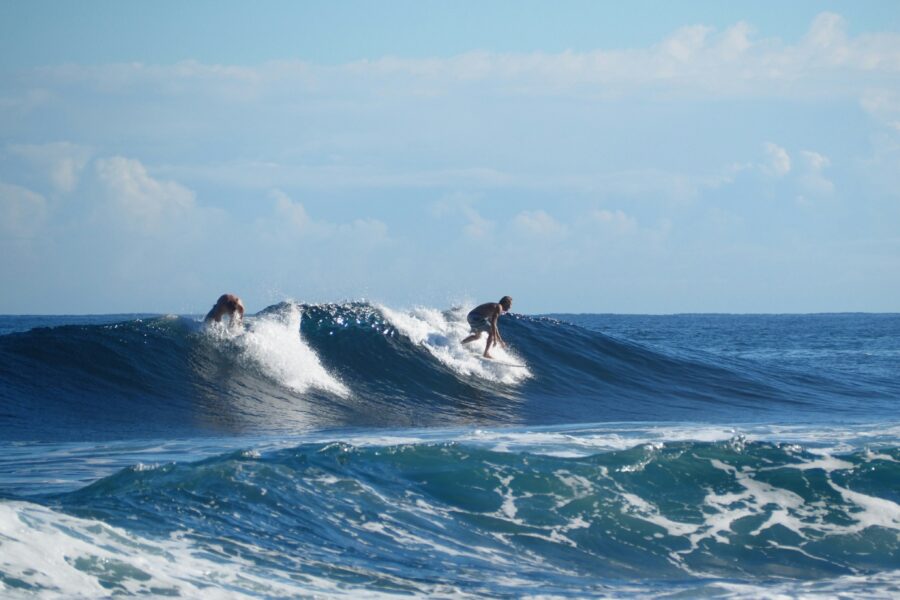 surfers riding waves in rincon puerto rico