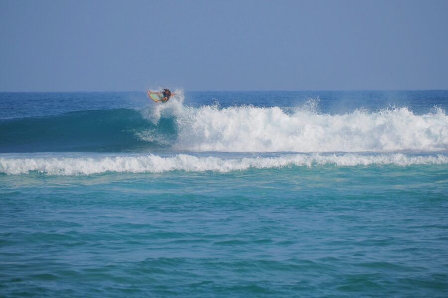 woman surfing a wave in rincon puerto rico