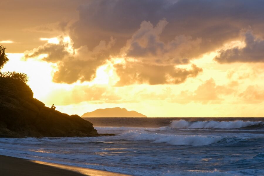 sunset at the beach in rincon puerto rico with island view