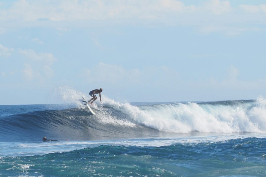surfer doing an air on a clean wave in puerto rico
