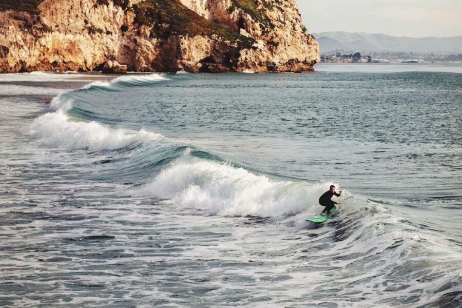 surfer riding small wave in california