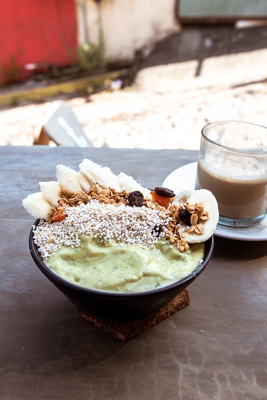 delicious looking smoothie bowl with banana granola and bee pollen