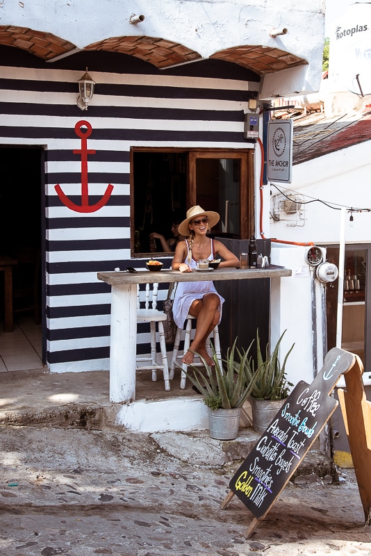 woman sitting at outdoor cafe bar in punta mita