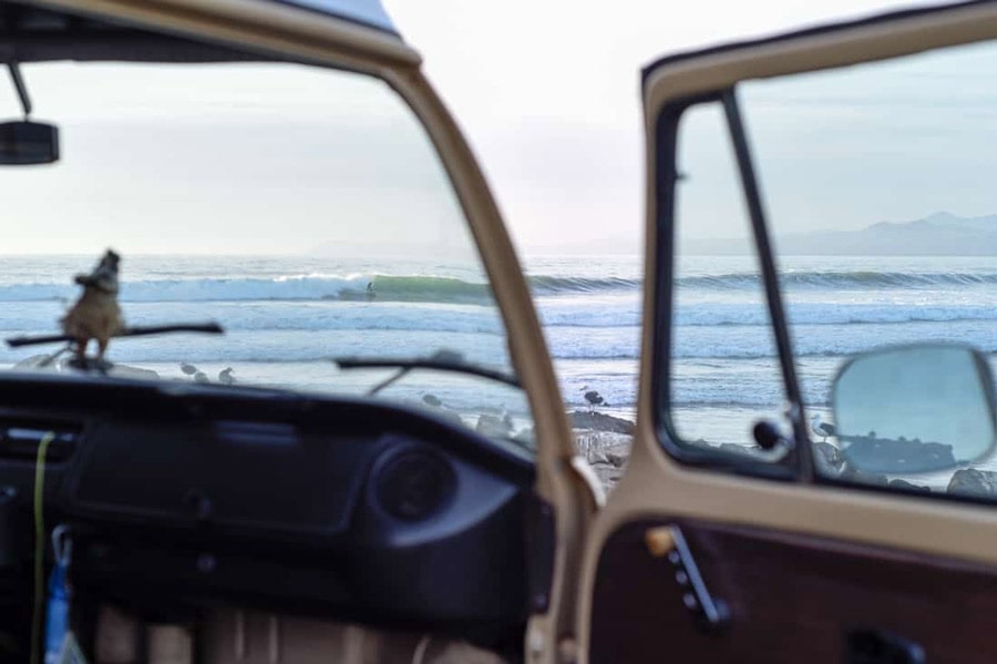 view of surfing through vw camper windshield from morro bay parking lot