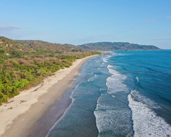 Tourists on the main strip of Santa Teresa on south coast of the