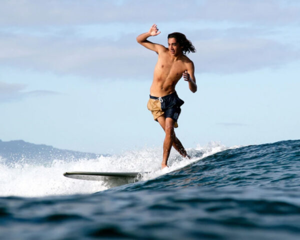 Surfer longboarding in Katin boardshorts