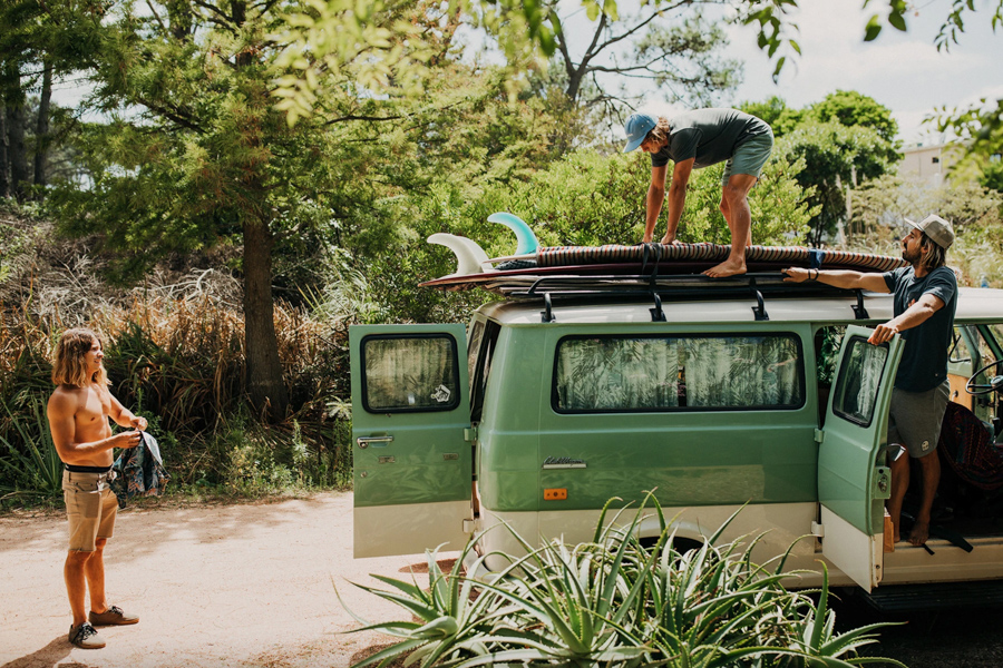 surfers loading car for surf trip - wearing Howler Brothers surf brand