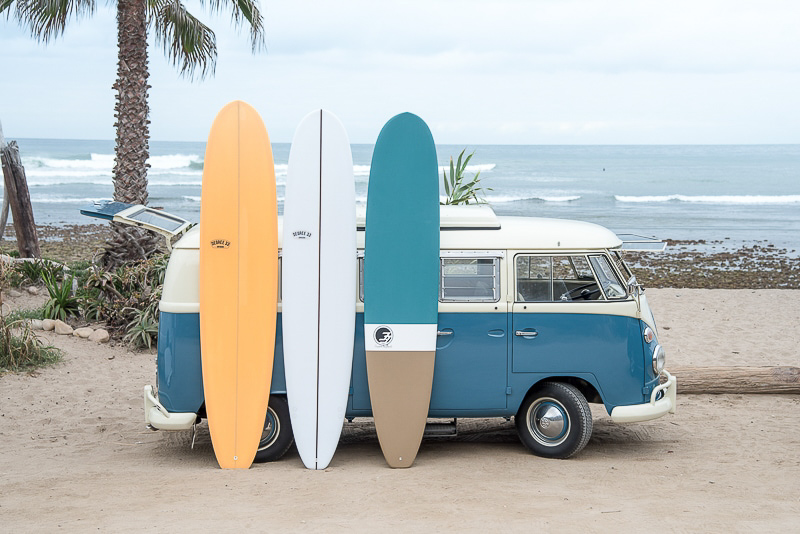 longboard surfboards with vw bus at the beach