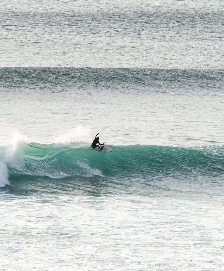 person surfing wave at impossibles bali