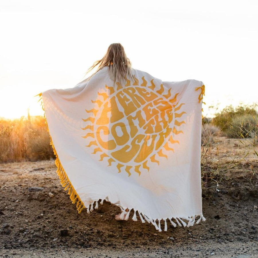 cute yellow beach blanket that says here comes the sun