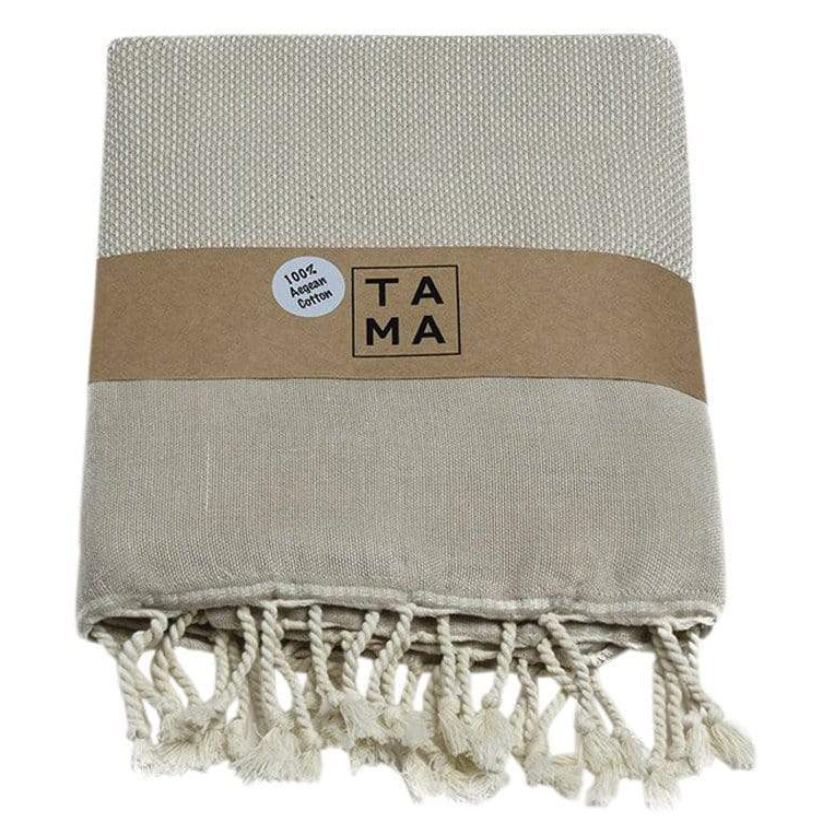 beige beach towel with white tassels