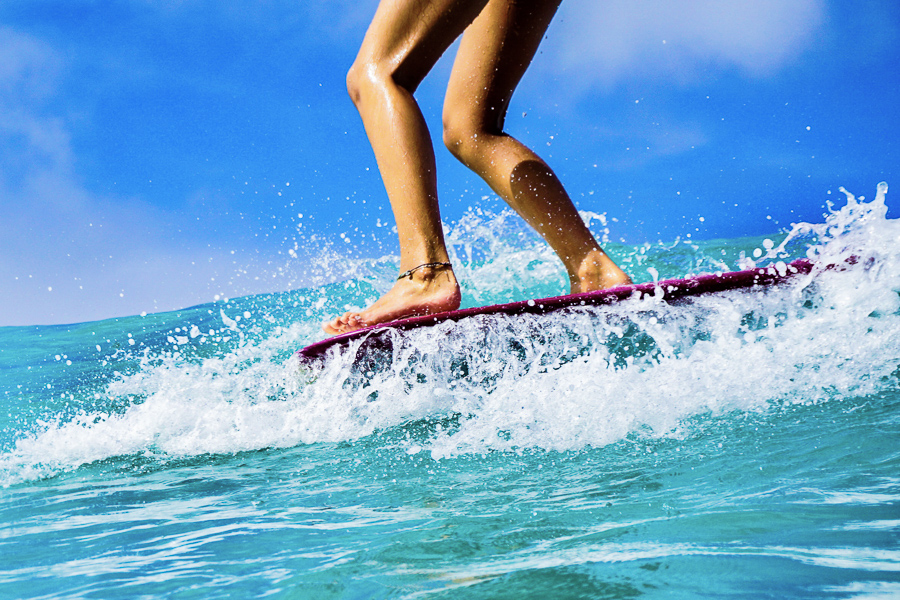 Surfer hanging ten noseriding on longboard