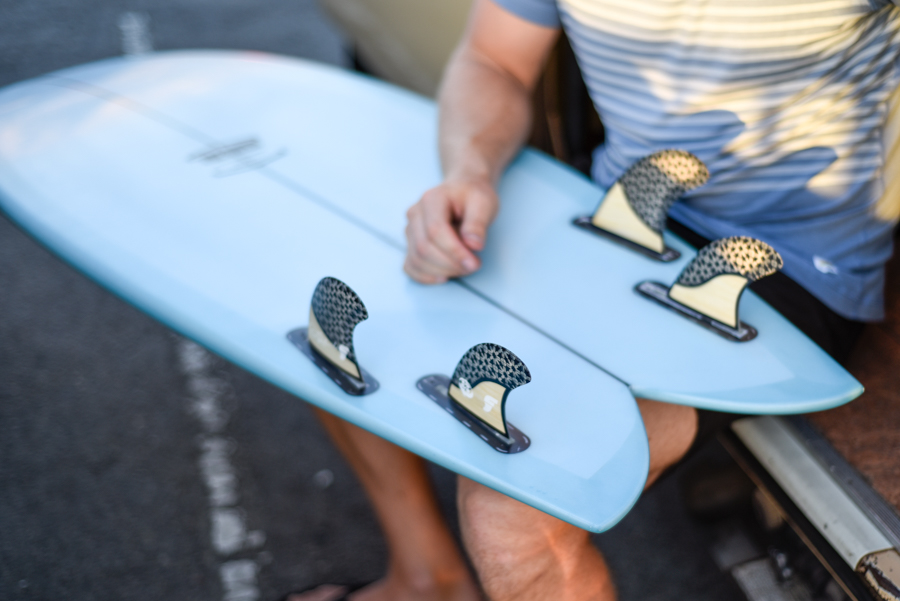 quad fins on a blue fish surfboard