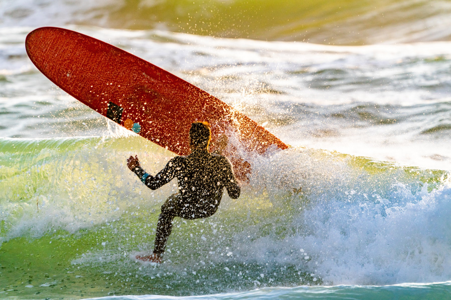 Surfer falling off of surfboard