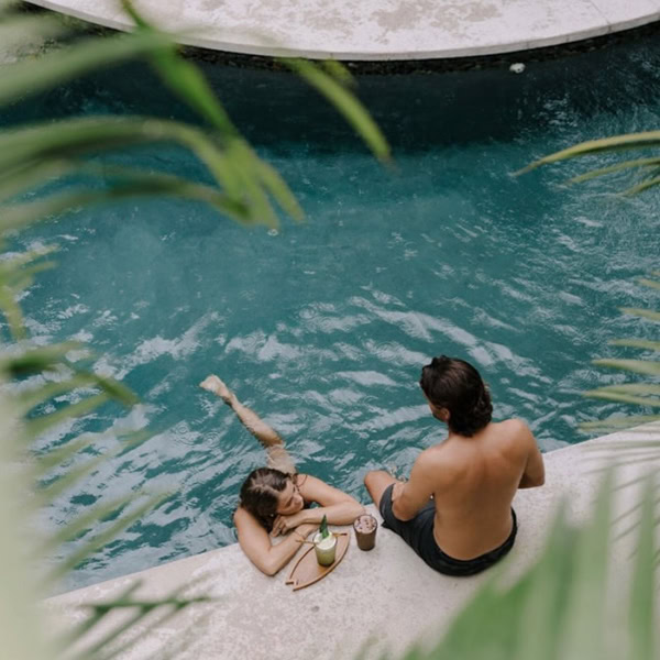 costa-rica-surf-trip-poolside couple poolside at boutique hotel